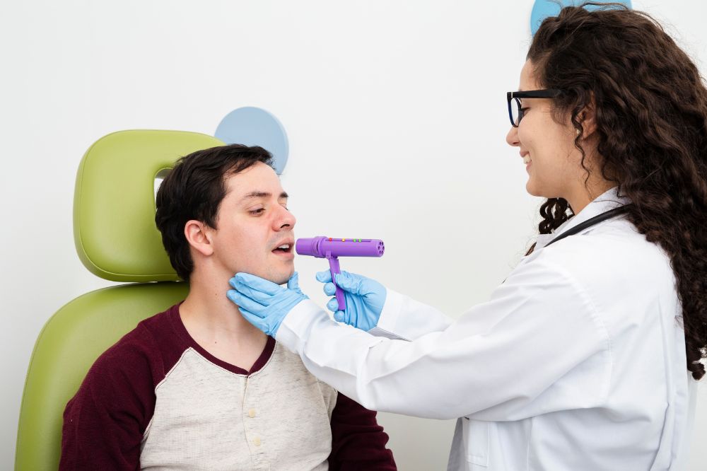 A patient performing myofunctional therapy exercises to improve tongue posture and nasal breathing in a Hamilton clinic.